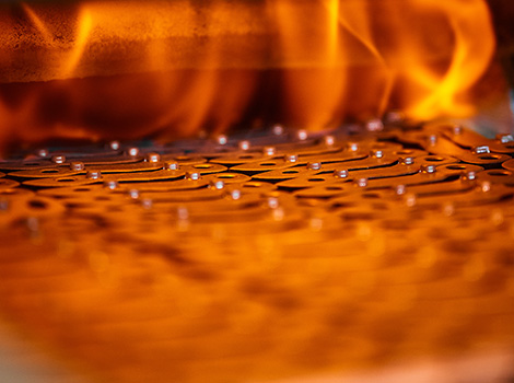 Flames heat treating metal